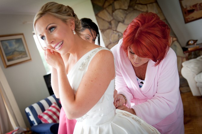 bride getting into wedding dres
